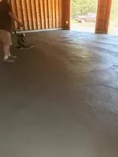 Fresh concrete foundation pour with wooden forms and support beams
